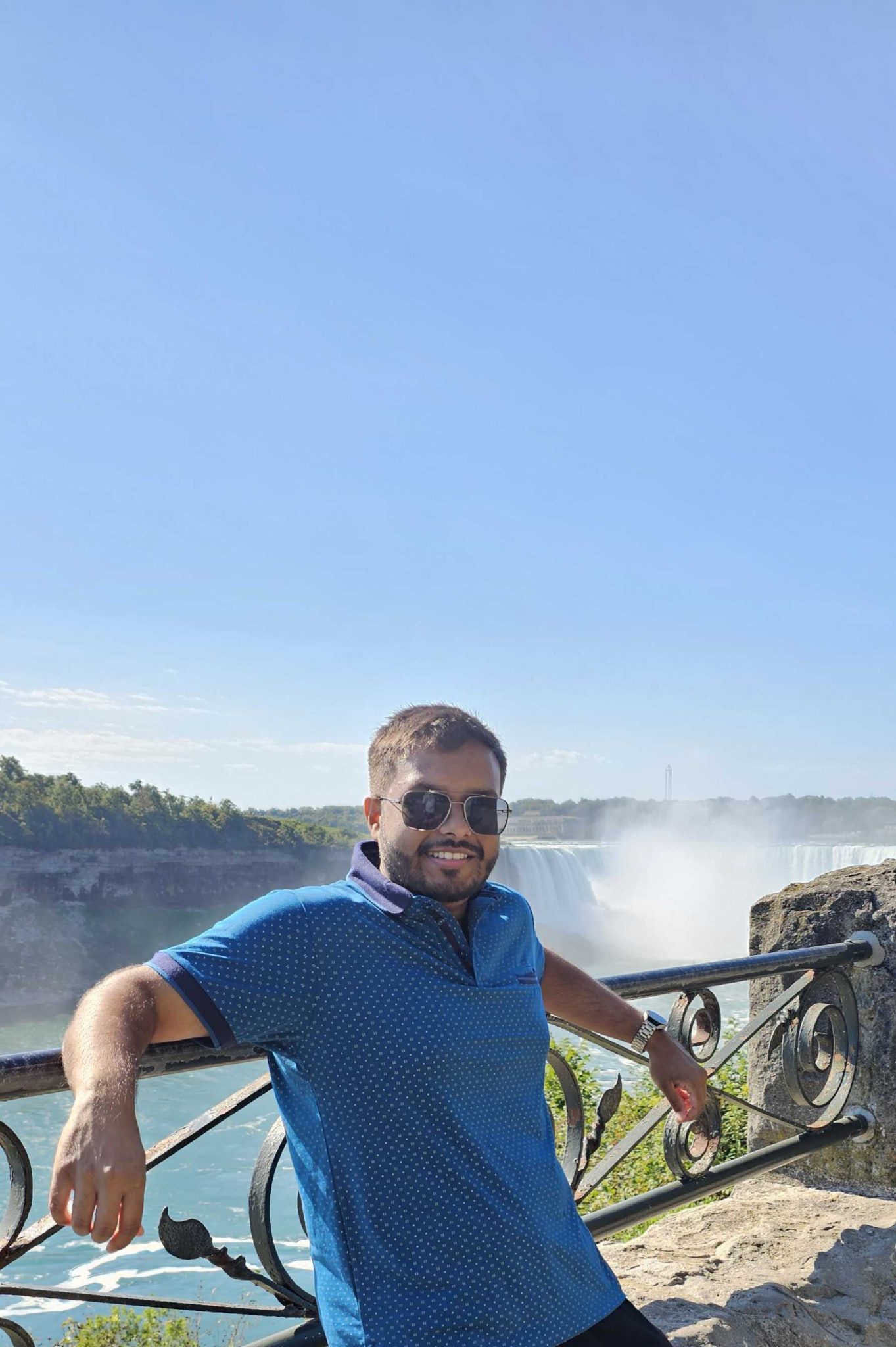 Siam standing by the railing overlooking Niagara Falls